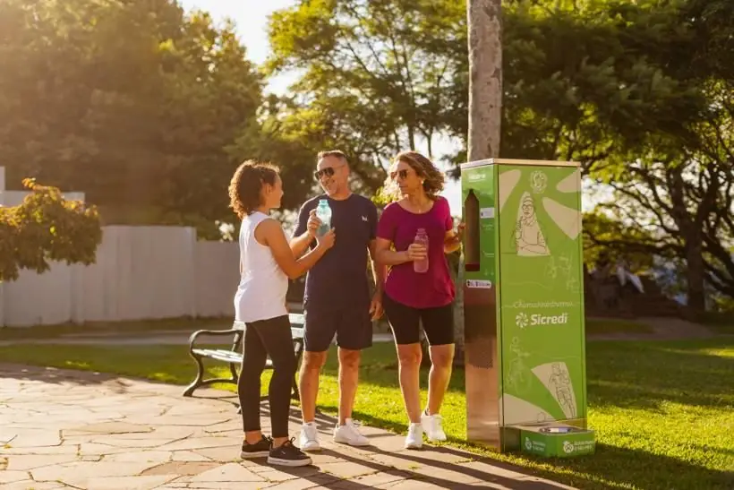 Família bebendo água na praça